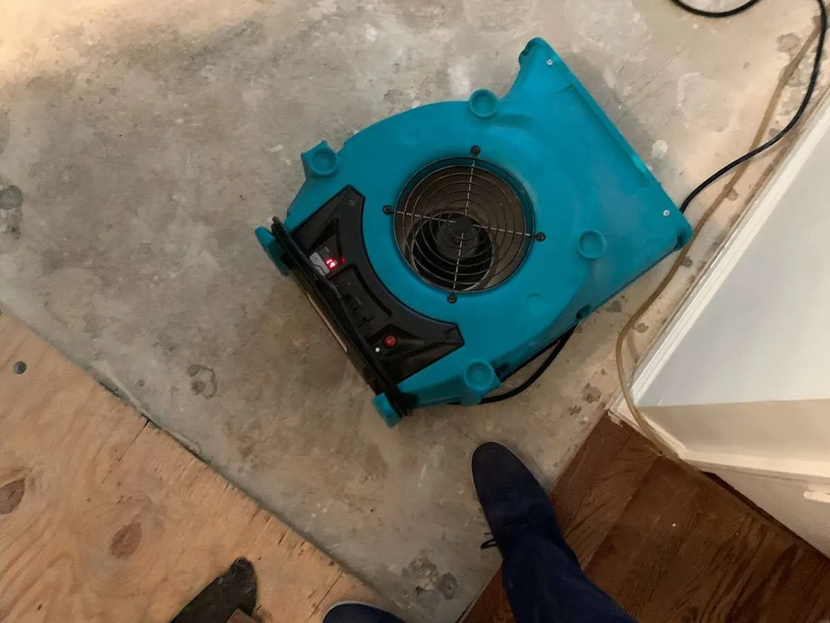 Air mover drying subfloor during Commercial Water Damage Restoration in Elizabeth City